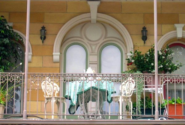 A balcony with an inviting tea table overlooks Disneyland, July 2004