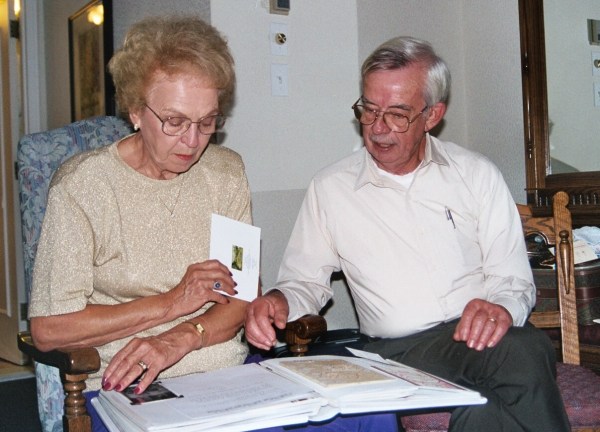 Mom and Dad enjoy an album of letters and cards from friends who wrote to congratulate them.