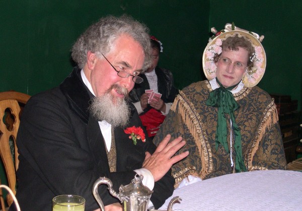 Charles Dickens reads Stave I of A Christmas Carol to enthralled listeners at the Green Man Inn. The Dickens Fair, San Francisco, December 2003