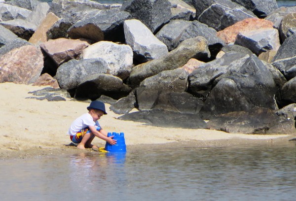 This young boy was too busy to notice I was taking photos of him as he worked. On the beach at Yorktown, Virginia, March 2014 