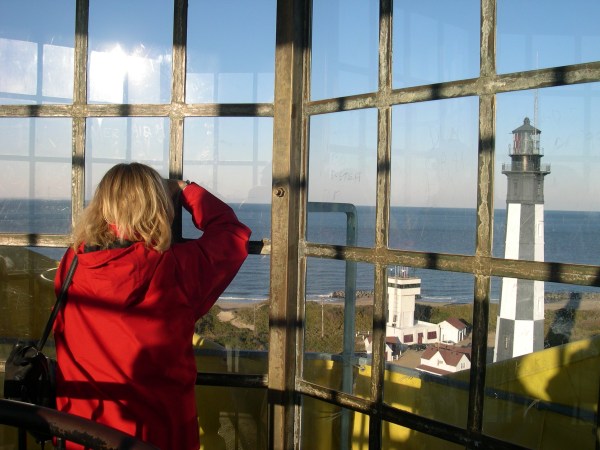 Looking out from one lighthouse to another.   Kathy photographs the newer lighthouse from the older one,  Cape Henry Virginia, April 2009. 