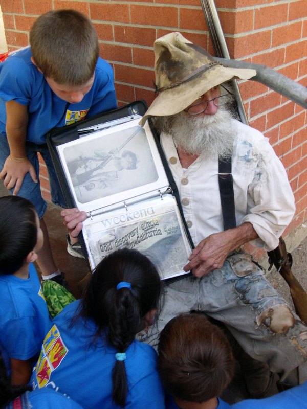 An old forty-niner takes school children back to the California Gold Rush. Coloma, California, July 2004