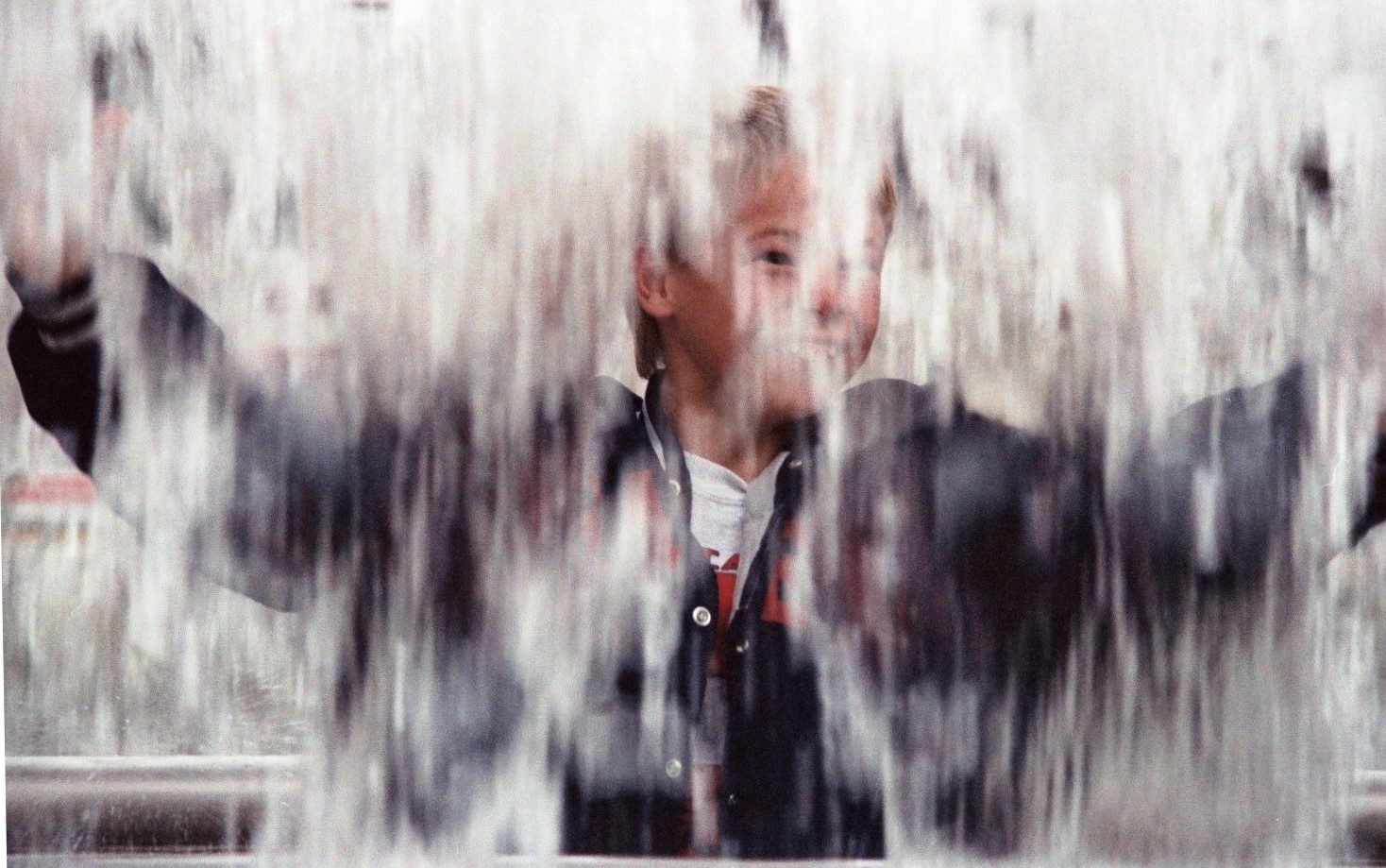 Drew was thrilled to look at the world from behind a waterfall. Westlake Park Fountain, near Pike Place Market, Seattle, 1993