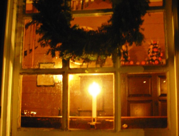 A candle-lamp shines through a window in Colonial Williamsburg, December 2008.